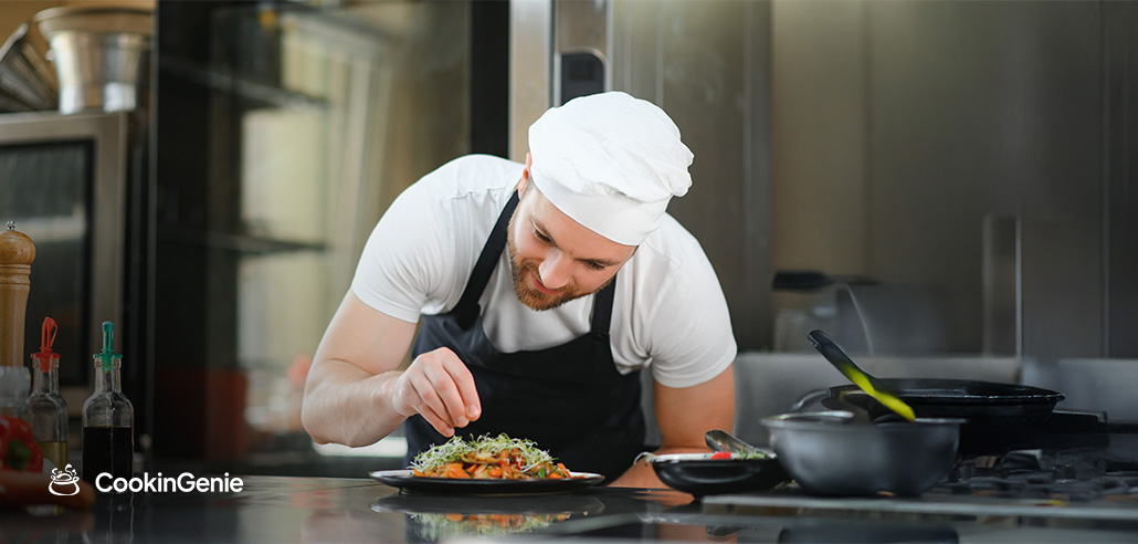 Chef plating a dish in a kitchen