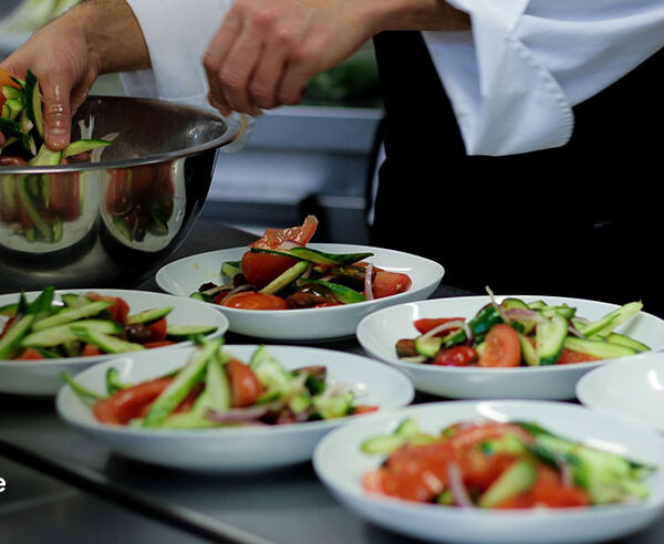 Personal chef plating fresh salad courses for a private dinner in Ohio
