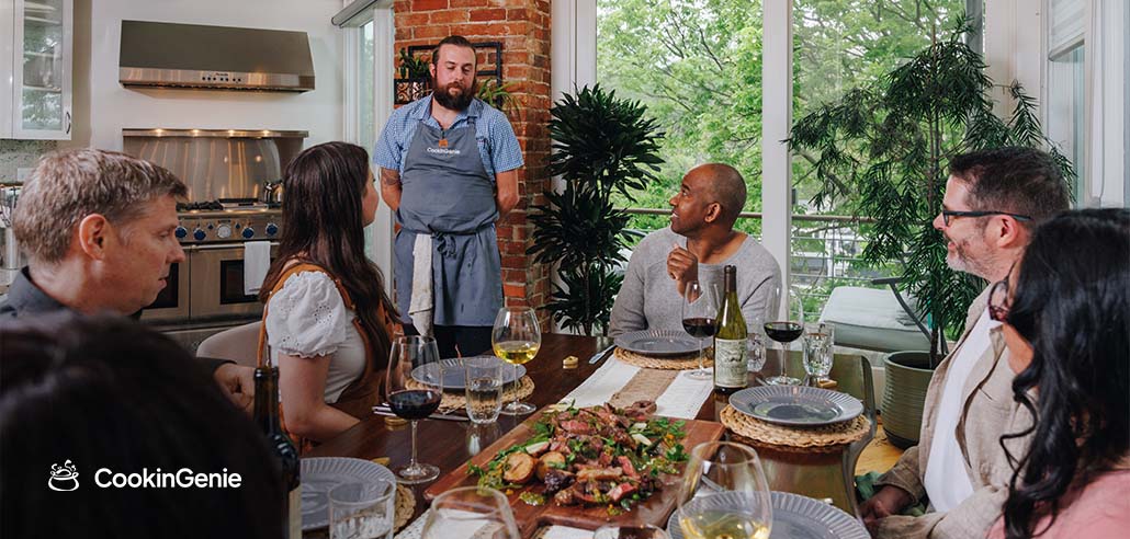 A private chef serving a curated meal to guests at a home dining table