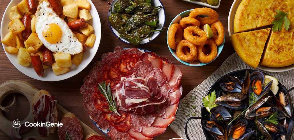 Spanish tapas spread with cured meats, patatas bravas, mussels, and calamari for a FIFA World Cup watch party