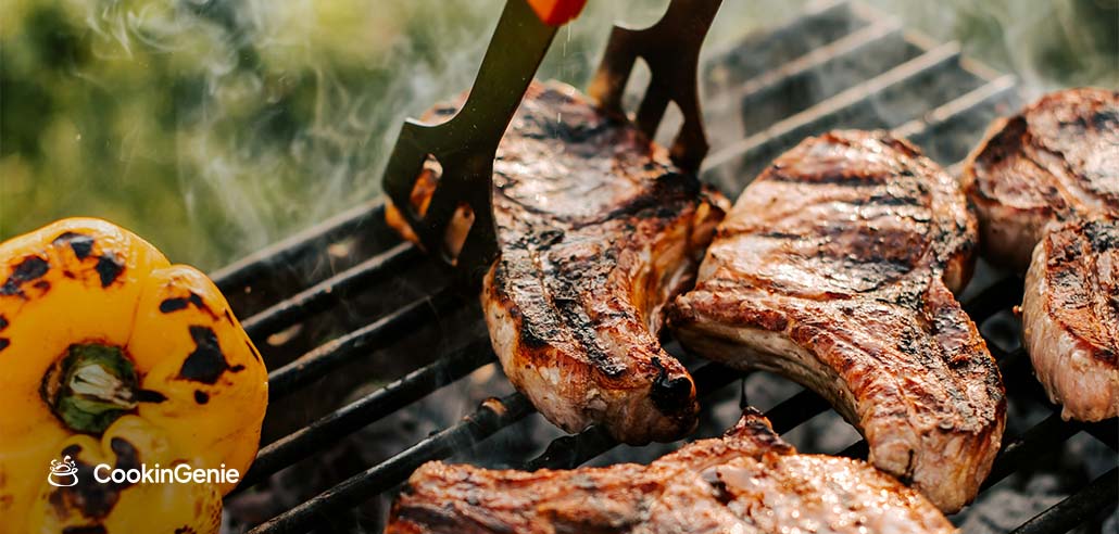 Private chef grilling steaks for a 4th of July party food menu during an outdoor summer cookout
