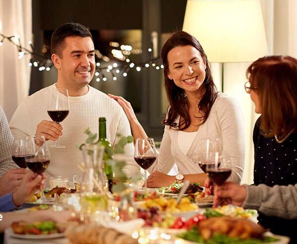 Family enjoying a private chef-prepared dinner at home in Fountain Valley with wine and fresh meals on the table