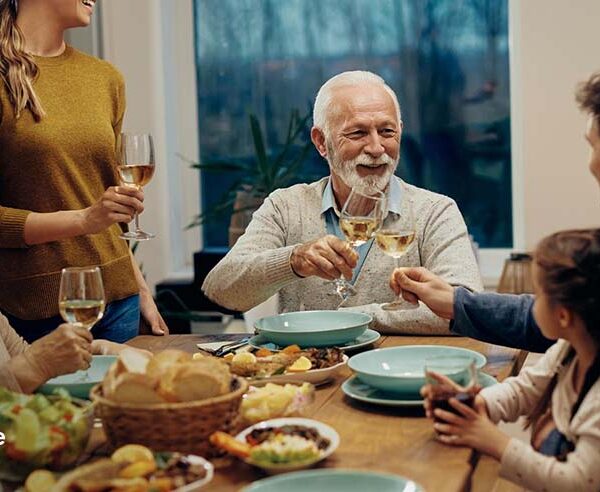Family enjoying a meaningful Father's Day dinner at home with loved ones gathered around the table