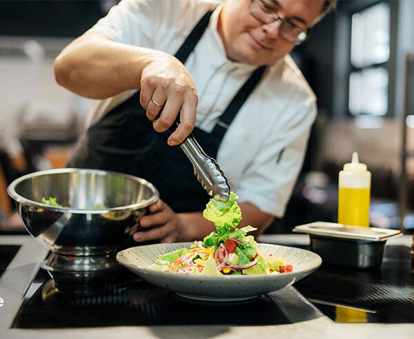 Private chef plating a fresh dish for a kaiseki dinner at home