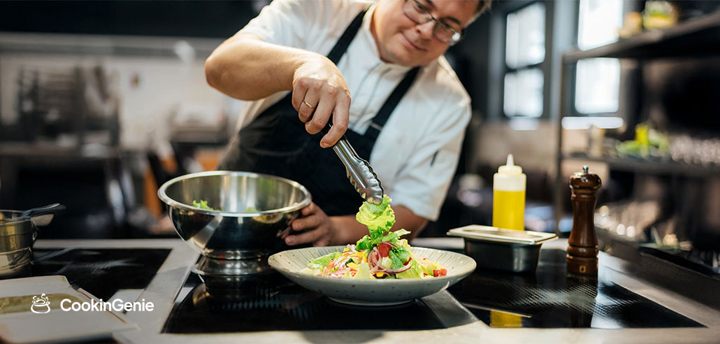 Private chef plating a fresh dish for a kaiseki dinner at home